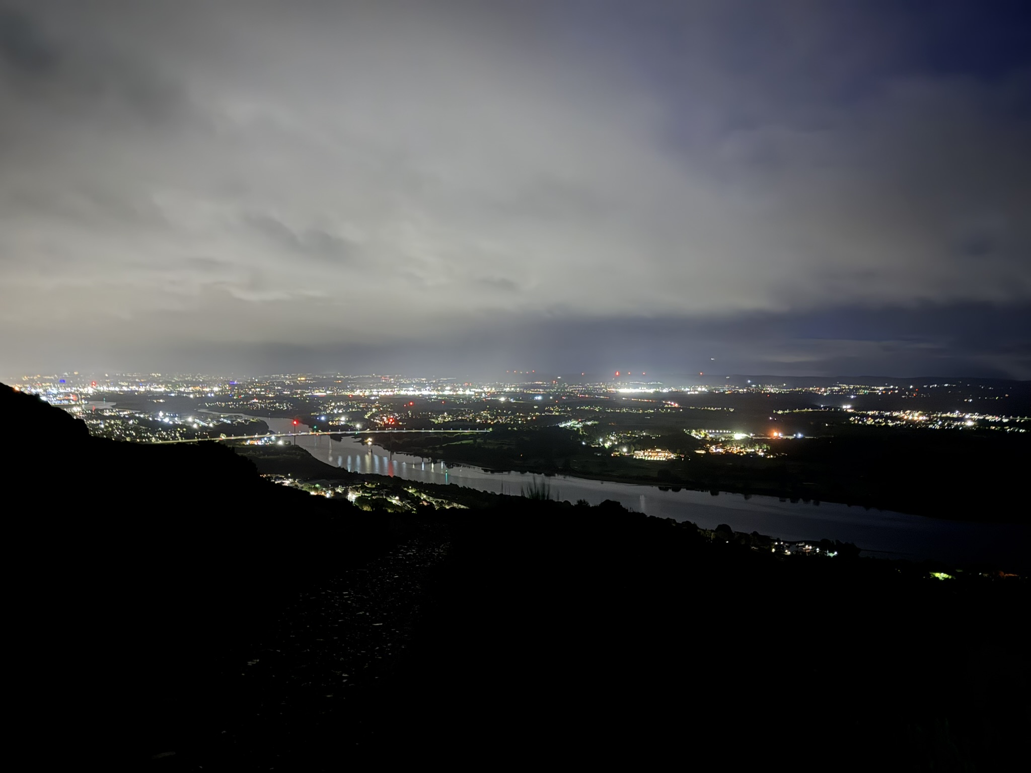 Wider night panorama of the Clyde and bridges, lights diffused by low cloud and damp air